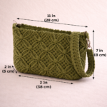 Handmade macrame handbag in green color with intricate cotton knot design placed on wooden table