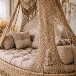 Macramé hanging daybed close-up with intricate cotton rope knots and beige cushions