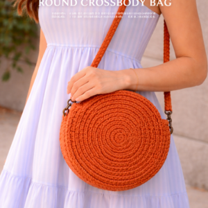 Handmade rust macrame round crossbody bag with spiral design and cotton rope strap on beige background