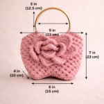 Handmade macrame rose handbag with floral knit design and gold handle, stylish purse for women displayed on wooden table