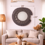 grey macrame wall mirror with fringe design styled above sofa in boho living room decor