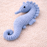 Handmade macrame seahorse toy in blue color