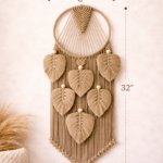 Handmade green and beige macrame dream catcher with leaf design and tassels in boho home decor setting