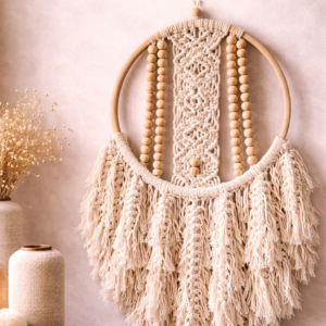 Handmade pink and offwhite macrame dream catcher with tassels in boho home decor setting (8 inch ring, 18 inch length)