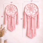 Handmade pink and off white macrame dream catcher wall hanging with tassels in boho home decor setting